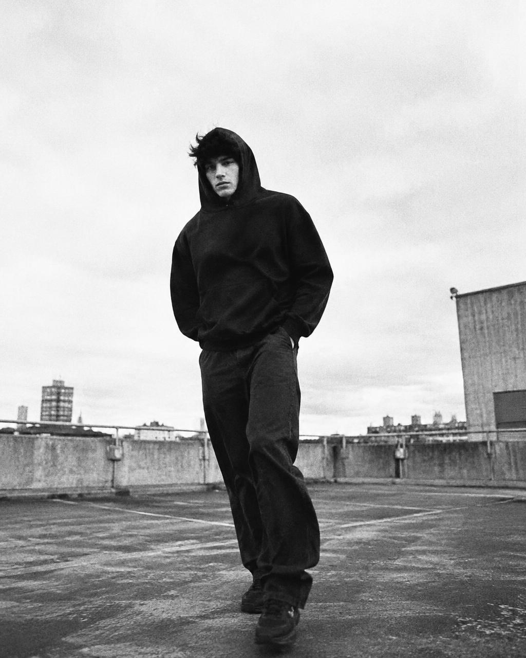 Model in TEEKYO hoodie on a rooftop