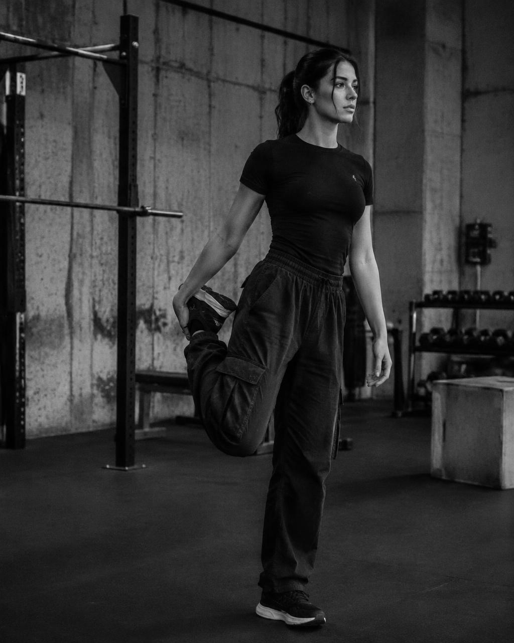 Model stretching in TEEKYO tee and cargo pants